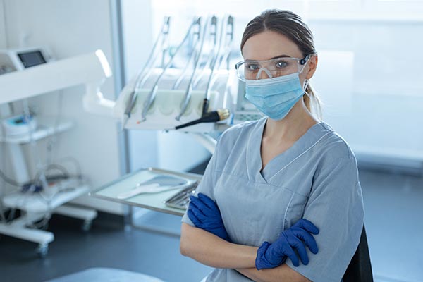 dentist wearing gloves mask safety goggles