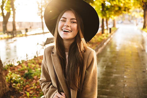 young woman in hat walking fall